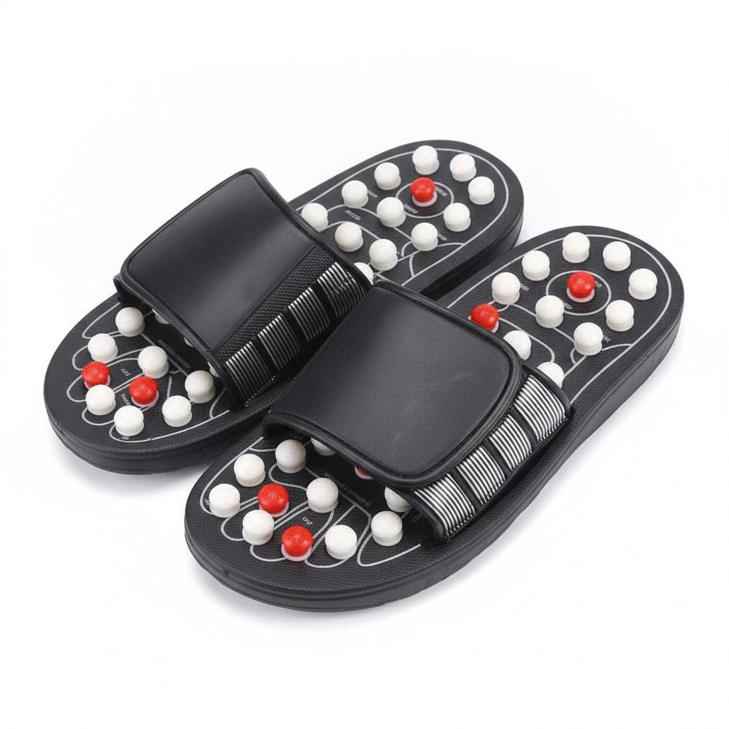 Ett par svarta massagetofflor med vita och röda noppor