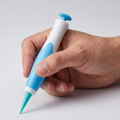 Hand holding blue skin tag removal applicator pen