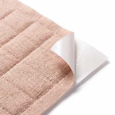 Close-up of quilted patch fabric with adhesive backing peeled