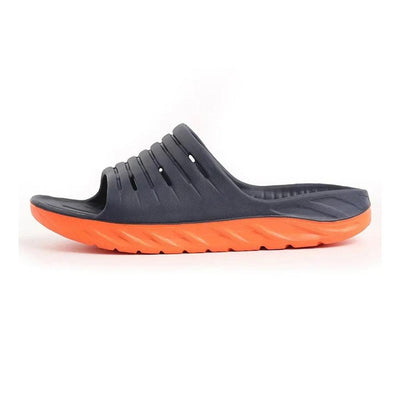 Marinblå slip-in-toffel med orange sula