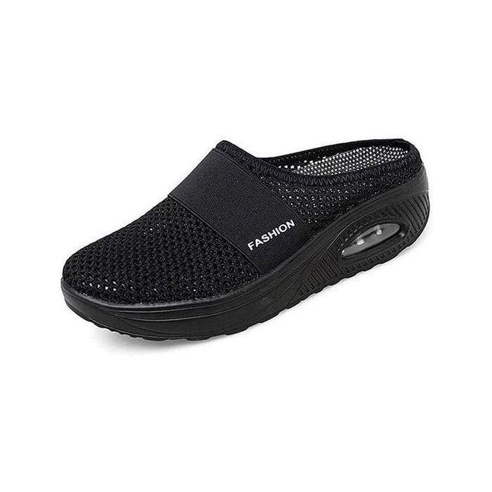 Svart stötdämpande slip-on-toffel med luftsula
